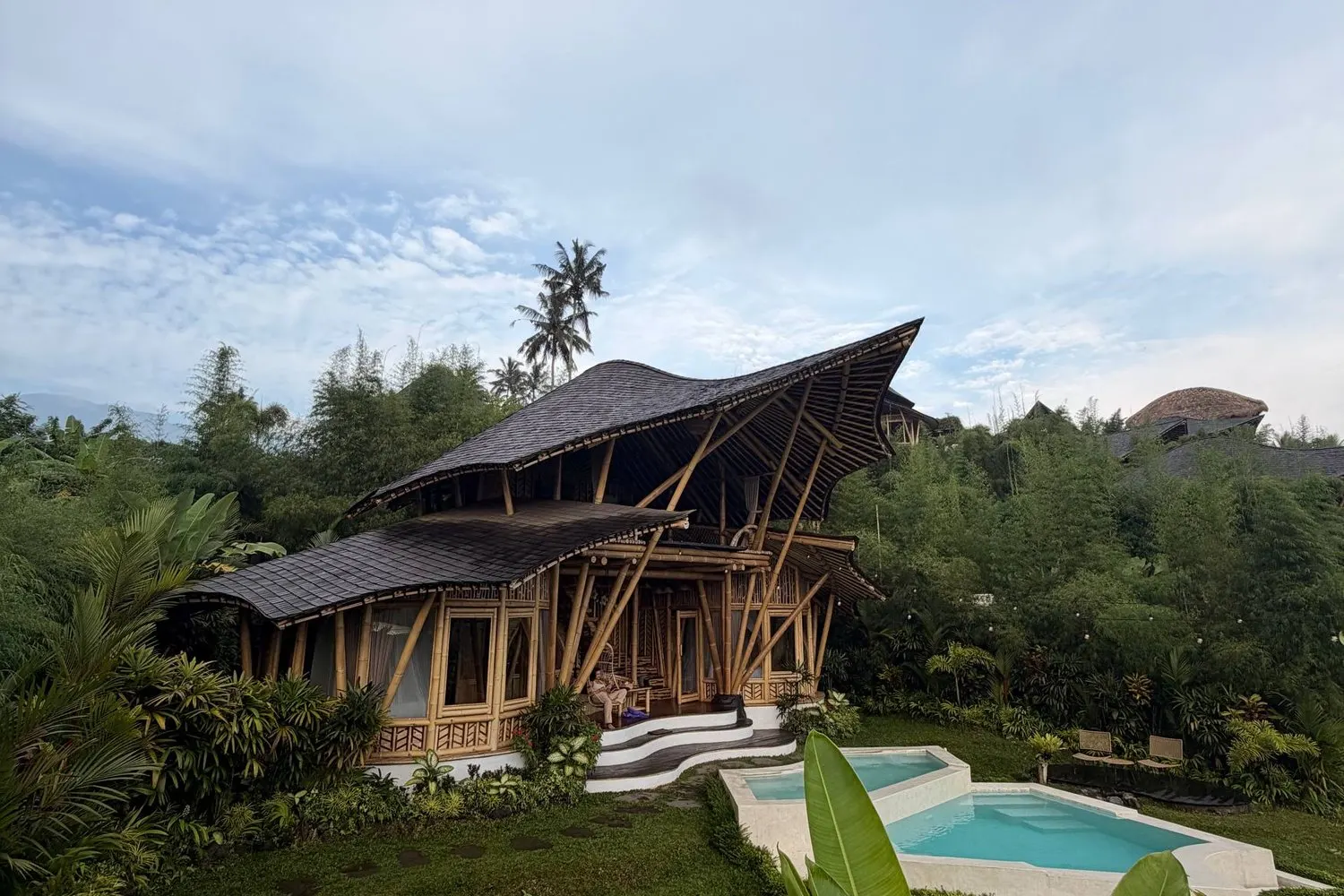 A bamboo villa with a private pool surrounded by jungle in Ubud, Bali.