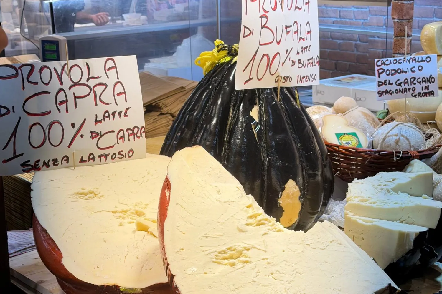 A cheese stall piled with provola at L'Artigiano in Fiera, Milan's Christmas market.
