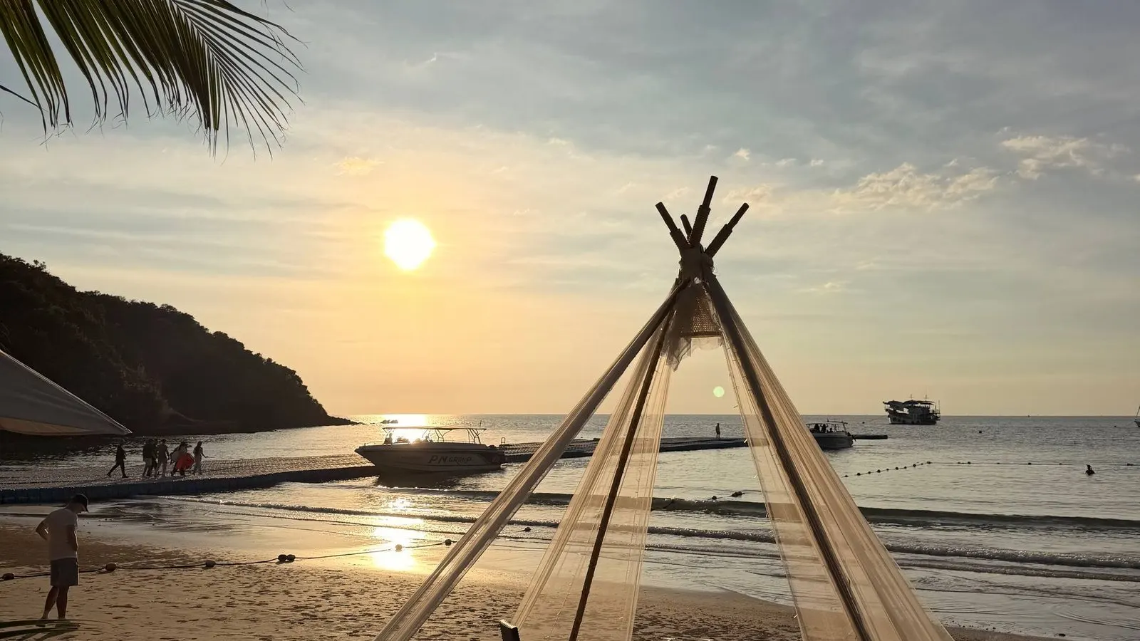 A sunset dinner setup on a quiet beach on Ko Samet, Thailand.